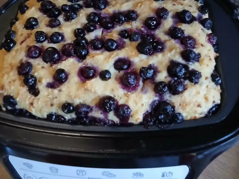 Bread pudding made with day-old bread, covered with blueberries in the pan of a Cake Factory